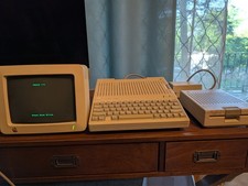 Apple IIc powers up. Includes Apple Works bundle. Manuals for startup. picture